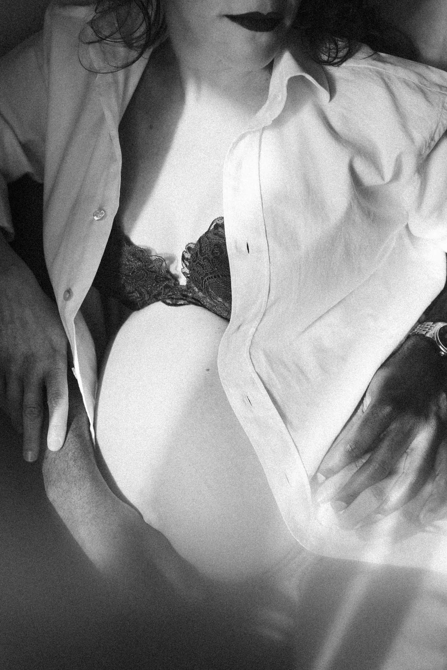 Beautiful sunlight falls on pregnant belly of woman during her in-home maternity photo shoot in Montreal