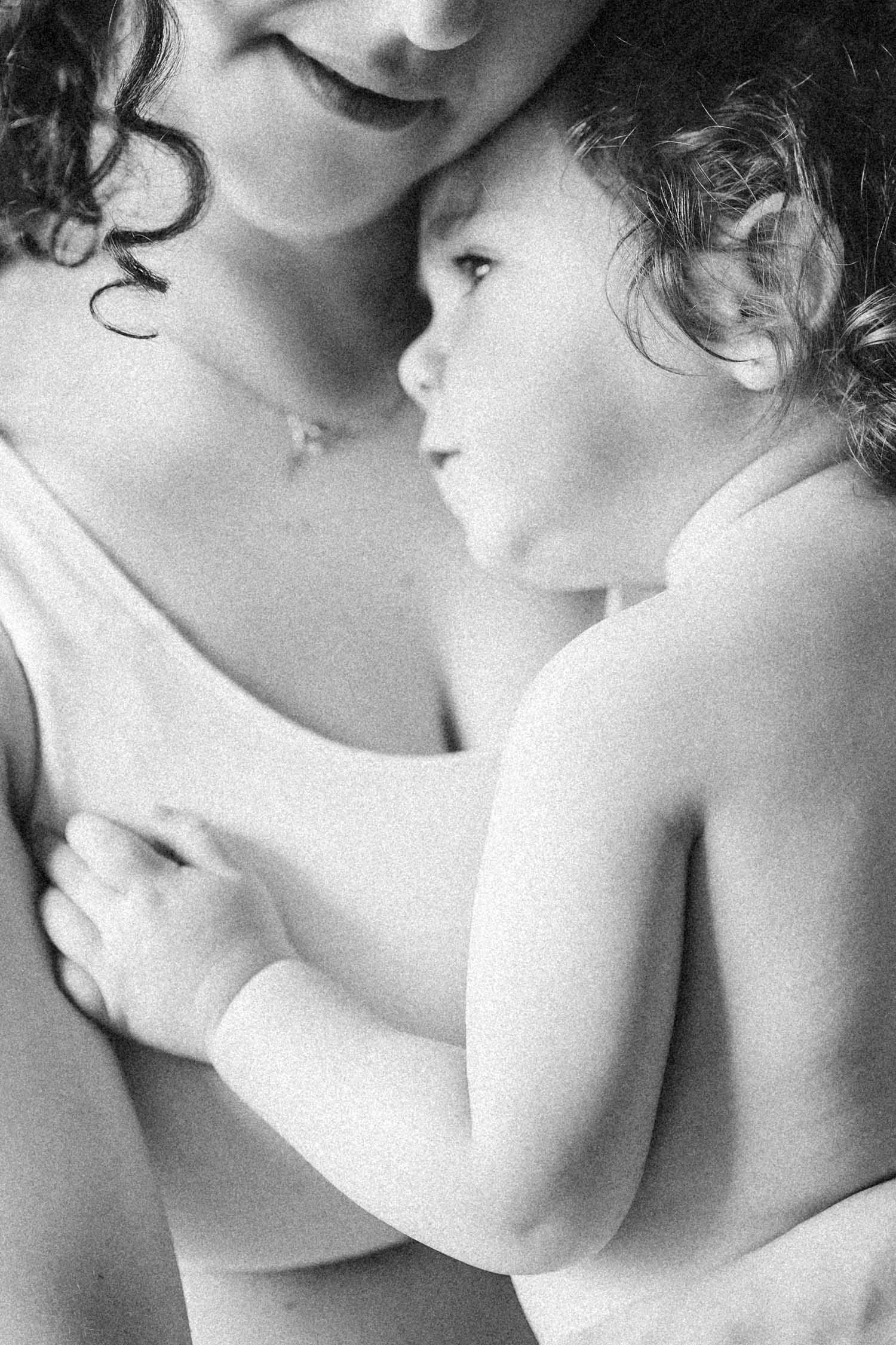 Baby rests her head on mom's chest during their in-home family photo session
